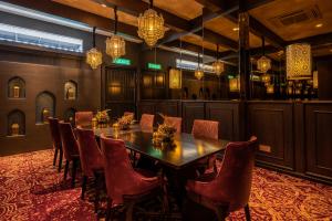 a dining room with a table and chairs and chandeliers at Bertam Resort & Water Park Penang in Kepala Batas