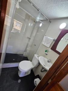 a bathroom with a toilet and a sink at Aparta estudio de la panamericana in Pasto