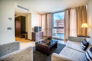 a living room with a couch and a tv at Abba Huesca in Huesca