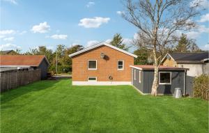 una casa con un patio con césped verde en Awesome Home In Snder Felding With Wifi, en Sønder Felding