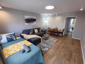 a living room with a bed and a couch at Gothic Heights Motel in Christchurch