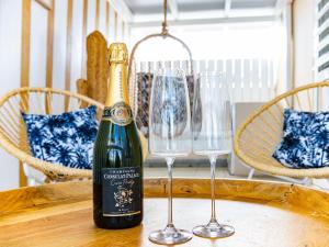 a bottle of champagne and two wine glasses on a table at Studio CASA SUN in Saint Martin
