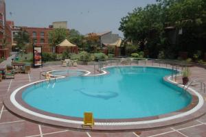 a large swimming pool in a courtyard at Cambay Sapphire, Gandhinagar in Gandhinagar