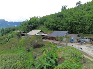 a group of buildings on a hill with trees at MAMA LILI'S HOMESTAY in Hao Su Ngai