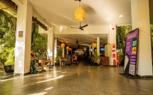 a building with a hallway with plants in it at Mad Monkey Hostel Phnom Penh in Phnom Penh +117 photos