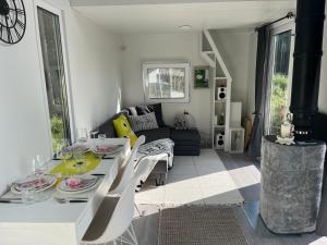 a white dining room with a table and chairs at Luxus Tiny House Saagala in Tornio