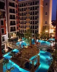 an overhead view of a building with a pool at night at Espana Condo Jomtien By AEY in Jomtien Beach