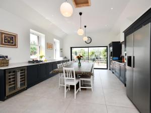 a kitchen with a table and chairs and a dining room at Albion House in Castle Douglas