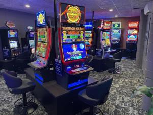 a bunch of slot machines in a room with chairs at Paringa Hotel Motel in Renmark