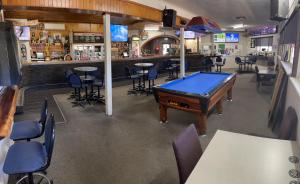 a bar with a pool table in a restaurant at Paringa Hotel Motel in Renmark