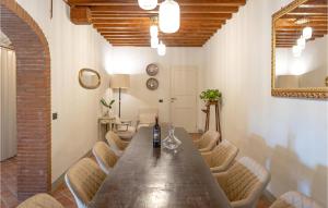 una sala da pranzo con un lungo tavolo in legno e sedie di Gorgeous Home In Castiglion Fiorentino a Polvano