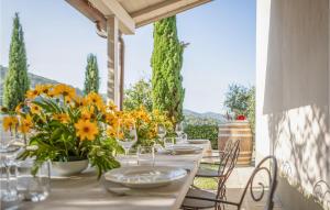 uma mesa com copos e vasos com flores em Awesome Home In Castiglion Fiorentino With Kitchen em Polvano