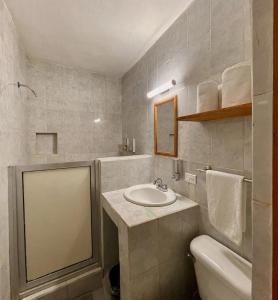 a bathroom with a sink and a toilet at Baja Real Hotel Boutique in La Paz