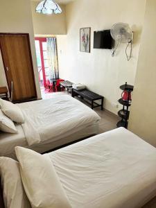 Postel nebo postele na pokoji v ubytování Hotel BB Inn @ Cameron