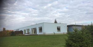 a white house in a yard with a grass field at Cosy house in Center of Tartu in Tartu