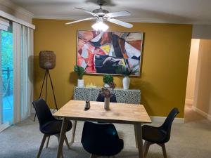 a dining room table with chairs and a ceiling fan at Lovely and cozy apartment- Rancho in Rancho Palos Verdes