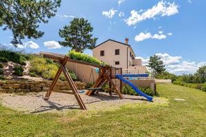 a playground with a slide in a yard with a house at Luxury Pool Villa Gradin - Happy Rentals in Gračišče