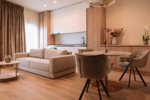 a living room with a couch and a table at La Boheme Corbeanca - partener Therme in Ostratu