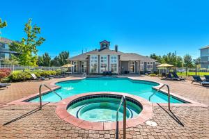 a swimming pool in front of a house at 2 Jumbo King Beds w Pool 4K TVs Close to Hill AFB in Clearfield
