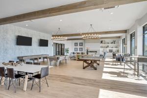 a living room with ping pong tables and chairs at Stunning Corporate Housing Near Hill AFB and DCC in Clearfield