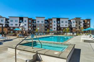 a swimming pool in a apartment complex at Brand New Lux Apartment - Year Round Pool - HAFB in Clearfield