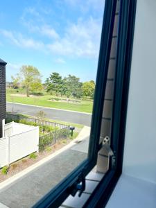 a view of a street from a window at A&J Queen bedroom-Quiet and brand new with reserve view in Auckland