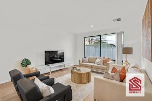 a living room with two couches and a tv at Bunbury Beach Splendor: Where Dolphins Dance in Bunbury