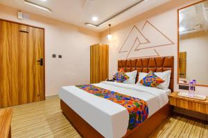 a bedroom with a large bed in a room at FabHotel The Palace in Vadodara