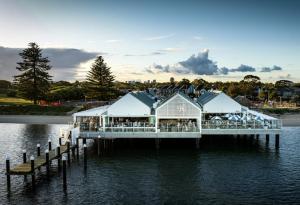 a restaurant on a pier on the water at Hotel Style Monterey Guest Studio near Hospitals, Beach and Airport in Sydney