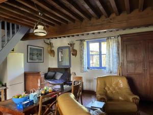 a living room with a couch and a table at Maison Bleue in Lavault-de-Frétoy