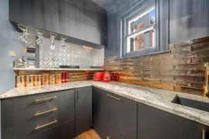 a kitchen with gray cabinets and a counter top at Celestial Suite Free Park Thermal Oasis Session in Hobart