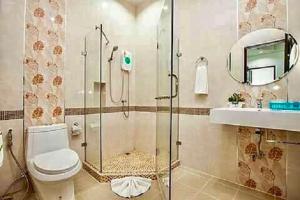 a bathroom with a shower and a toilet and a sink at Baan Noppadol Hua Hin Resort in Hua Hin