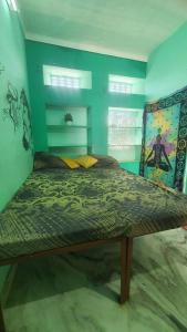 a bedroom with a large bed in a room at ANAND HOSTEL in Pushkar