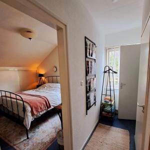 a bedroom with a bed and a book shelf at Carmen's Stay In - Jaagweg 13 Ilpendam in Ilpendam