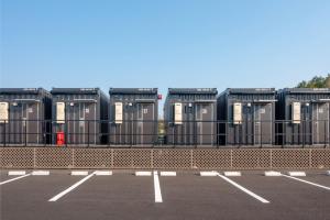 a row of portable toilets in a parking lot at HOTEL R9 The Yard Narita Kukou Nishi in Narita