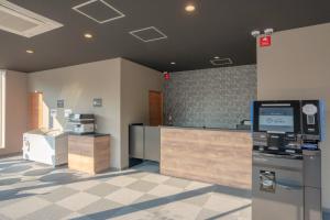 an empty lobby with a cash register and a cash drawer at HOTEL R9 The Yard Narita Kukou Nishi in Narita