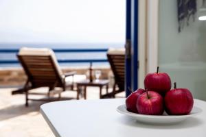 zwei Äpfel, die auf einer Platte auf einem Tisch sitzen in der Unterkunft Aura Paros in Logaras