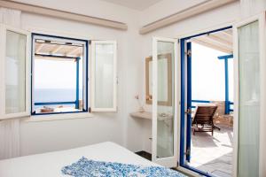 a bedroom with a view of the ocean at Aura Paros in Logaras