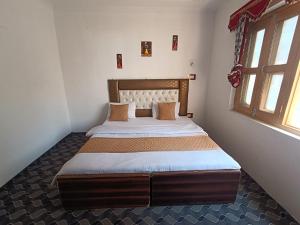 a bedroom with a large bed in a room at Shamus Javed Homestay in Srinagar