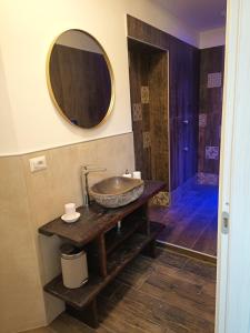 a bathroom with a sink and a mirror on the wall at Alloggio delizioso DOMODOSSOLA ROOMS in Domodossola