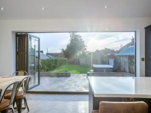 a kitchen with a large sliding glass door to a patio at Doves Nest in Ashbourne