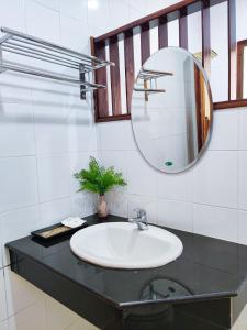 a bathroom with a sink and a mirror at Nan Bluesky Resort and Spa in Nan