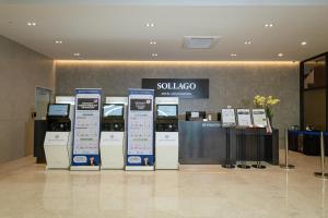 a store with several kiosk machines in a lobby at Sollago Myeongdong Hotel & Residence in Seoul