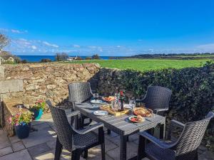 a table with food and drinks on a patio at Mulberry Cottage - Uk45432 in Isle of Whithorn