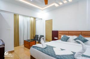 a bedroom with two beds with white towels on them at Hazy Heights 360 in Munnar