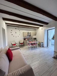 a living room with a couch and a table at La casa nel Borgo Sospeso "con vasca e vista panoramica" in Vitorchiano