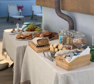 a table with bread and other foods on it at nautilus b&b suite design in Follonica