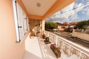 a balcony with potted plants and a view of a street at Stella Studios in Lixouri