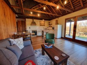 a living room with a couch and a table and a kitchen at Chandlers Rest 