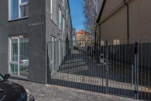 a wrought iron fence in front of a building at cohost I New Bastėja Life Apartments w-Garage Prkg & Self Check-in in Vilnius